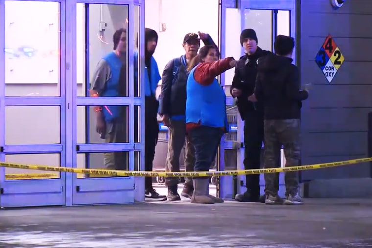 Walmart workers talk to police in South Anchorage on Sunday.