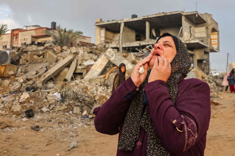 A Palestinian woman reacts as people inspect the damage following Israeli strikes on Rafah, in the southern Gaza Strip, on Nov. 20, 2023.