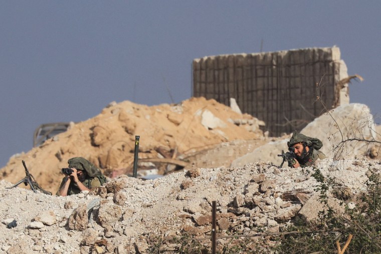 sraeli soldiers scan an area in the Zeitoun district in the southern Gaza Strip on Nov. 19, 2023.