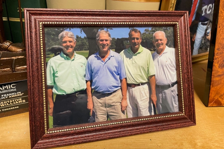 A framed photograph showing Rep. Roger Williams, left, President George W. Bush, and House Speaker John Boehner.