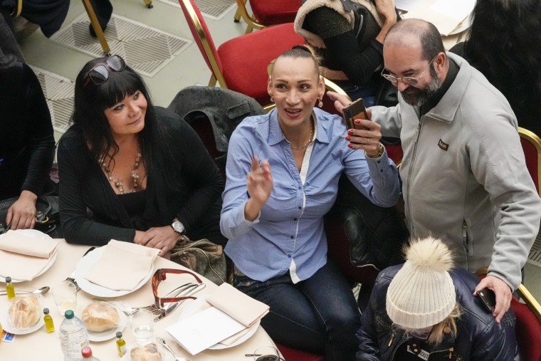 Don Andrea Conocchia, right, with members of a group of transgender women he accompanied at a lunch for the poor with Pope Francis at the Vatican, Sunday, Nov. 19, 2023. 