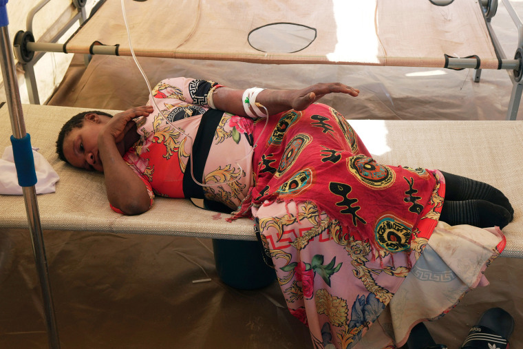 A cholera patient lies on a hospital bed, in Harare.