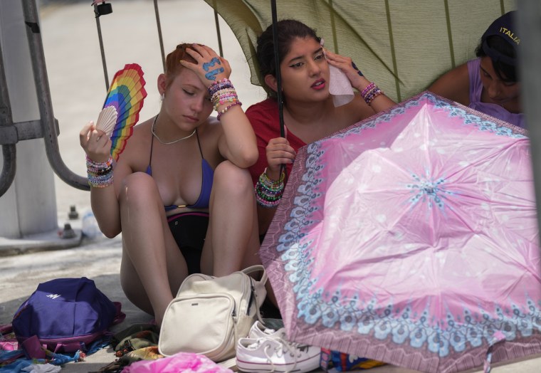 Taylor Swift fans wait for the doors of Nilton Santos Olympic Stadium to open for her Eras Tour concert amid a heat wave in Rio de Janeiro on Saturday.