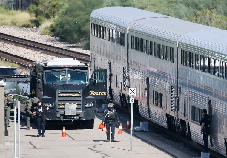  A police SWAT truck is parked near the last two cars of an Amtrak train in downtown Tucson, Ariz., after a shooting in 2021. 