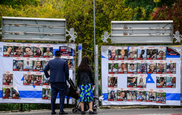 People look at billboards.