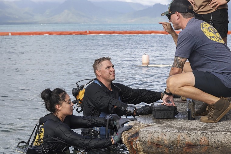 U.S. Navy sailors retrieved the aircraft flight recorder from a downed P-8A Poseidon and are debriefed in waters just off the runway at Marine Corps Air Station Kaneohe Bay, in Hawaii on Thursday, Nov. 23, 2023. 