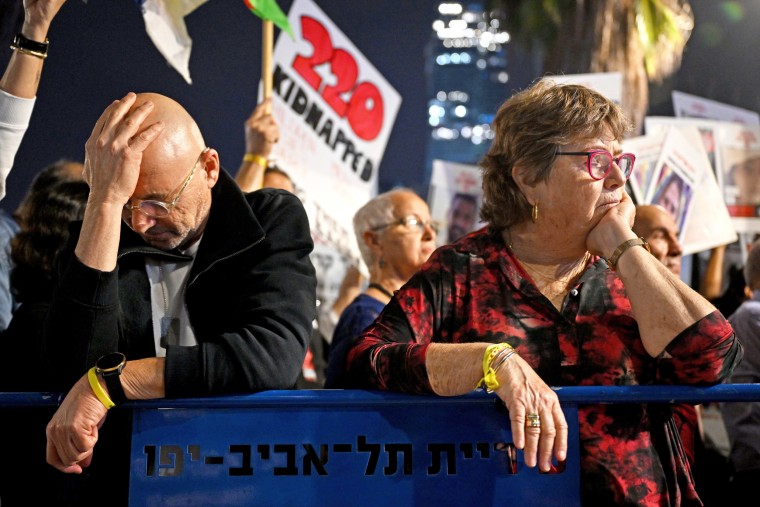 A man and woman look distressed during a rally. 