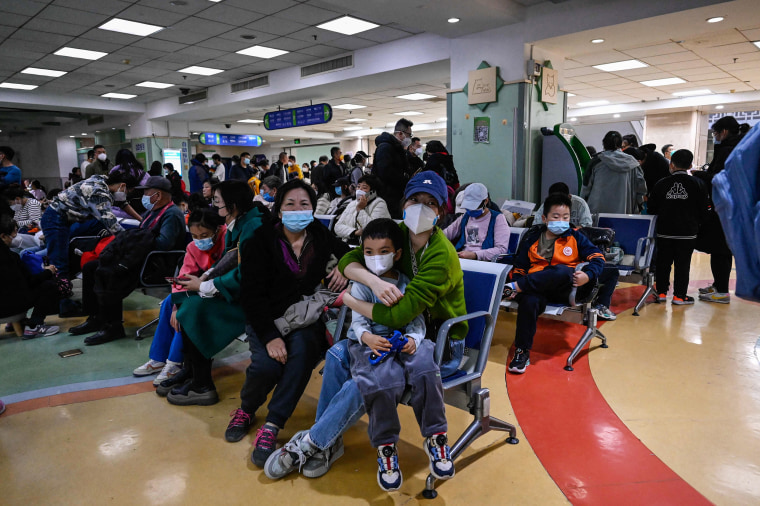 Children and their parents wait at an outpatient area at a children hospital in Beijing on November 23, 2023. A surge in respiratory illnesses across China that has drawn the attention of the World Health Organization is caused by the flu and other known pathogens and not by a novel virus, the country’s health ministry said Sunday.
