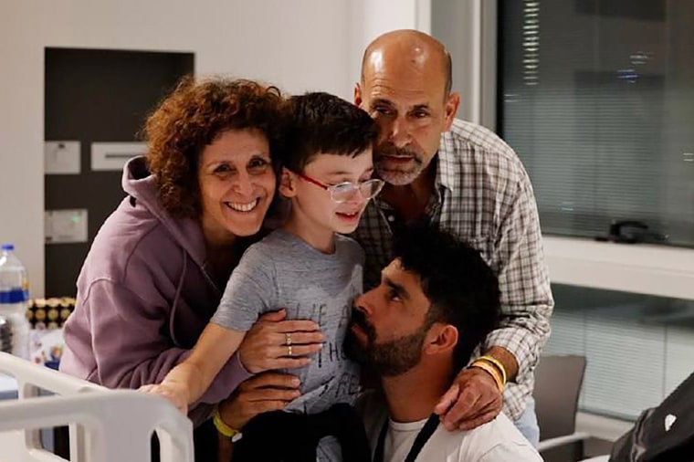 Keren Munder, left, and her son Ohad, center, at the Schneider Center for Pediatric Medicine in Peta Tikvah, Israel, after their release Saturday.