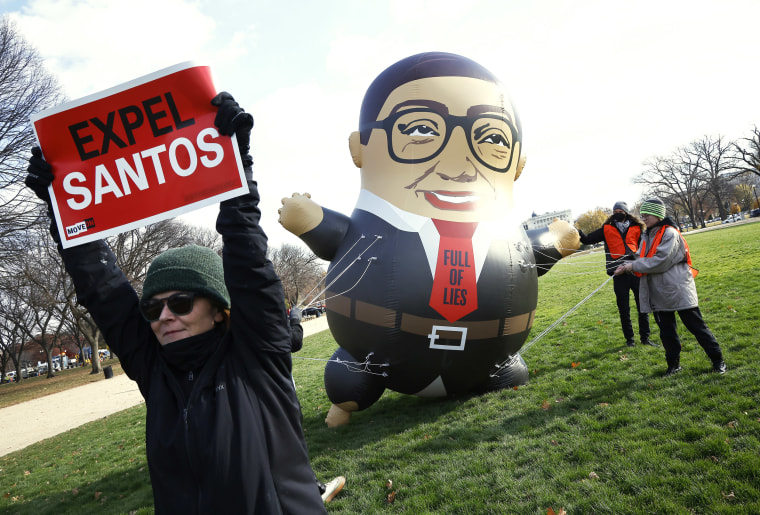 Activists hold a large inflatable balloon of Rep. George Santos as they advocate for his expulsion. 