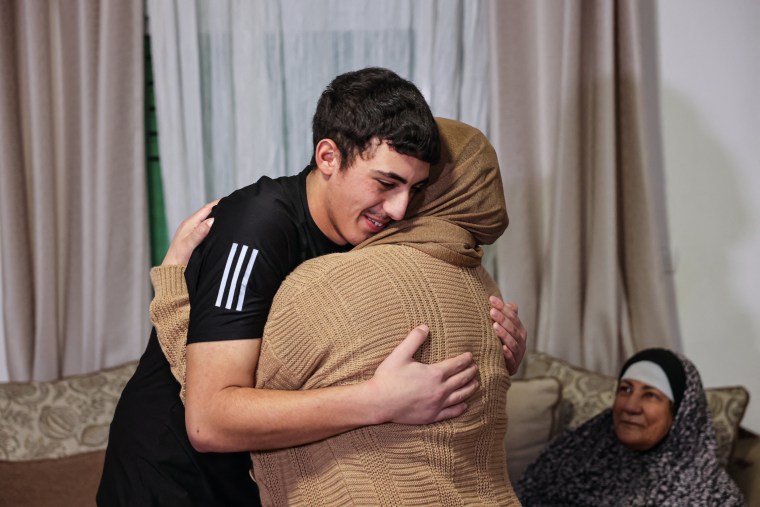 Palestinian Muhammad Abu Al-Humus hugs his mother upon returning to his home in east Jerusalem on Nov. 28, 2023, after his reIease from an Israeli prison. 