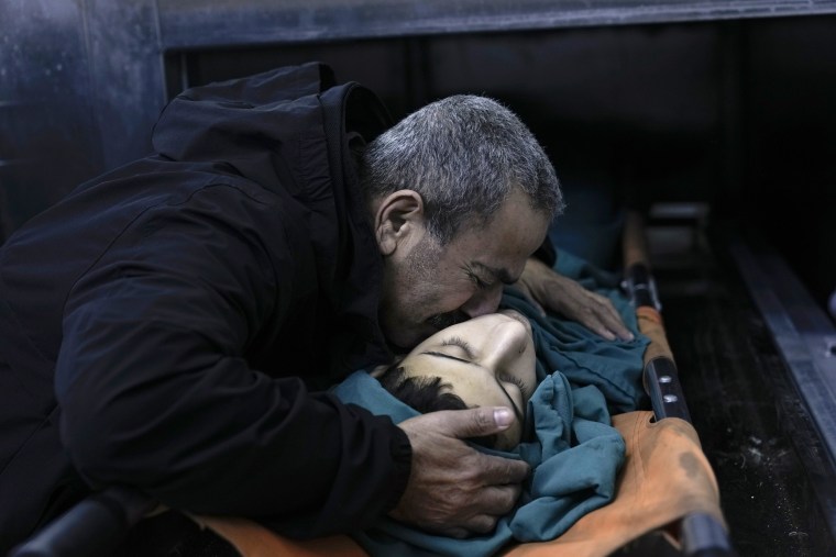 A relative mourns 15-year-old Basil Abu Al-Wafa, who was killed during an Israeli military raid on Jenin refugee camp in the West Bank on Wednesday, Nov. 29, 2023. 