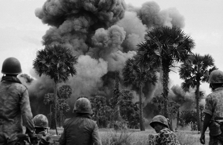 Smoke rises from bombs dropped by U.S. planes near the Cambodian capital of Phnom Penh on July 25, 1973, during Kissinger's tenure as National Security Adviser. 