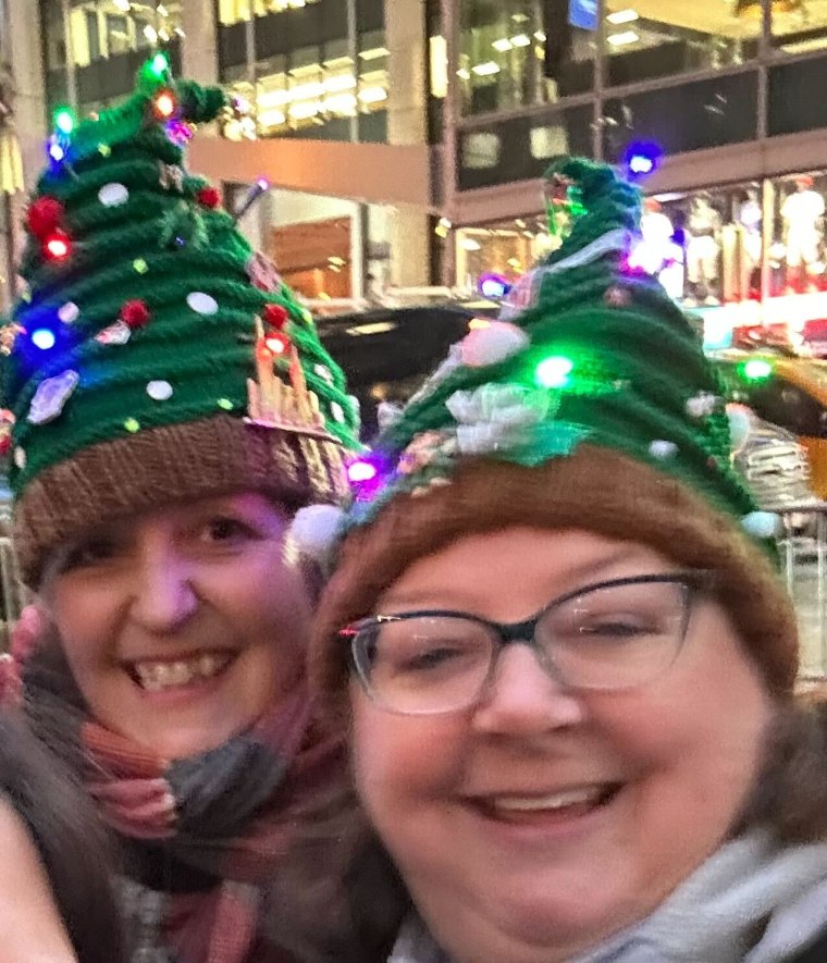 Kelly Anderson, left, and Laurel Schaffer are checking "watch the Rockefeller Center Christmas tree lighting" off their bucket list this year! (And absolutely ROCKING those hats, we must add.) 