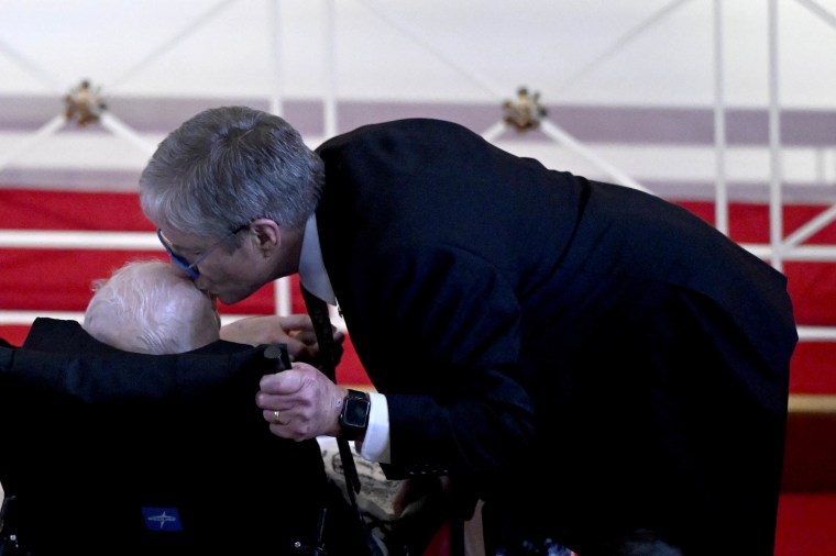 James "Chip" Carter kisses the head of his father, former US President Jimmy Carter, during a tribute service for former US First Lady Rosalynn Carter, at Glenn Memorial Church in Atlanta, Georgia, on November 28, 2023. Carter died on November 19, aged 96, just two days after joining her husband in hospice care at their house in Plains. 