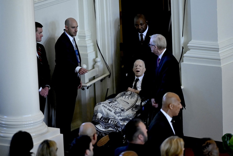 Former US President Jimmy Carter arrives for a tribute service for former US First Lady Rosalynn Carter, at Glenn Memorial Church in Atlanta, Georgia, on November 28, 2023. Carter died on November 19, aged 96, just two days after joining her husband in hospice care at their house in Plains.