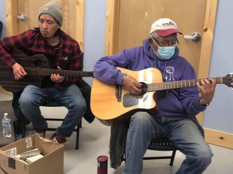 Willis playing guitar with his father