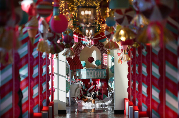 Candy-themed ornaments hand from the ceiling of the hallway between the East Wing and the Residence.
