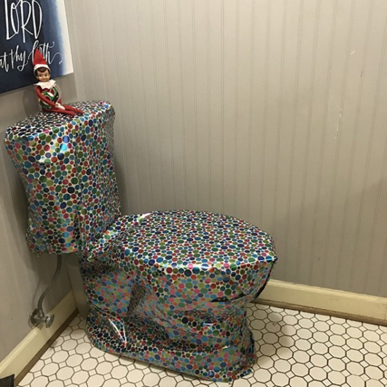 elf on the shelf on gift-wrapped toilet