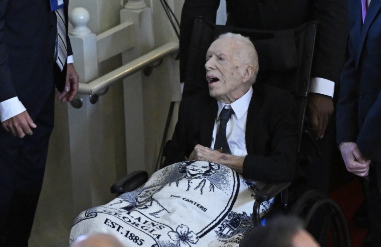 Former US President Jimmy Carter arrives for a tribute service for former US First Lady Rosalynn Carter