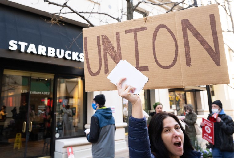 Steph Kronos, a pro-Union activist, joins Starbucks workers, former employees, and supporters in holding signs in support of a strike, outside of a Starbucks store 
