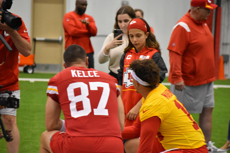 Myka Eilers strategizes with Kansas City Chiefs players Travis Kelce and Patrick Mahomes on the field as part of her Make-A-Wish experience in 2022.