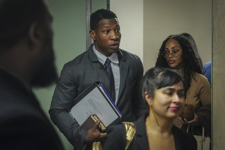 Actor Jonathan Majors, center, arrives at court for his domestic abuse trial Tuesday in New York. 