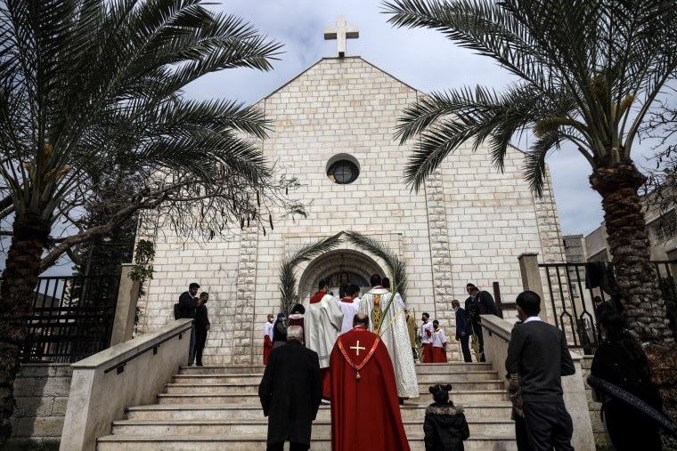 Palestinian Christians arrive to attend the Palm Sunday mass at the Holy Family  Catholic church in Gaza City, on March 28, 2021.