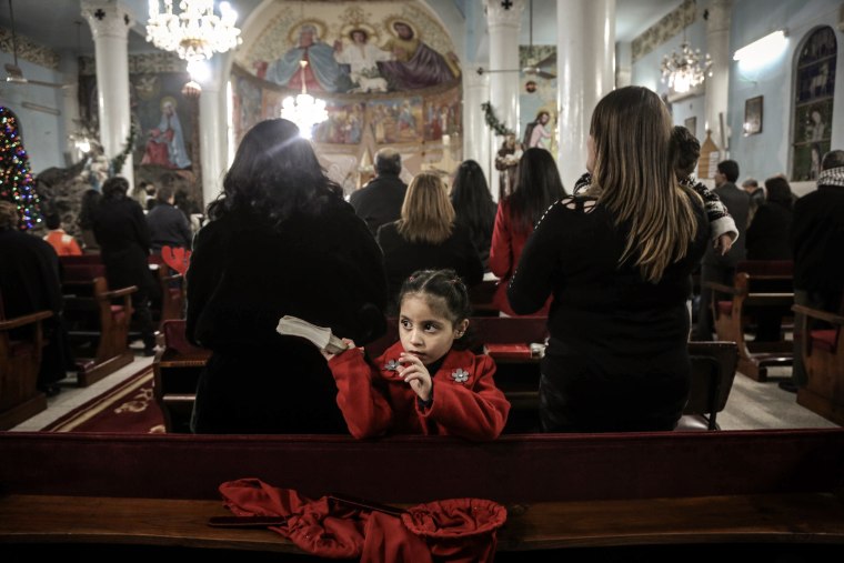Palestinian Christians attend a Christmas Eve mass at the Holy Family Catholic Church in Gaza on December 24, 2016.