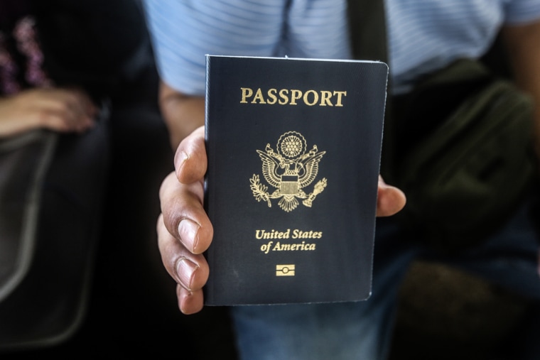 A US citizen holds his passport while waiting at the border crossing between the Gaza Strip and Egypt. 