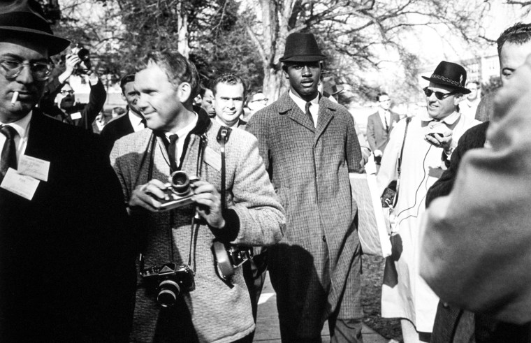 Harvey Bernard Gantt, the first African-American student admitted to Clemson University  surrounded by photographers and reporters as he enters the University's Admissions office in in Clemson, S.C. in January, 1963. 