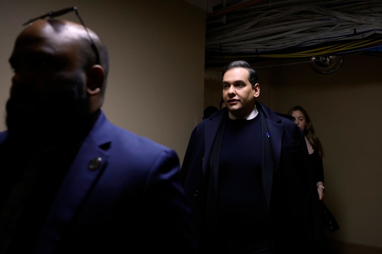 Rep. George Santos, R-N.Y., and members of his staff walk through the tunnel connecting the Capitol Hill office buildings with the U.S. Capitol ahead of a vote to expel him.
