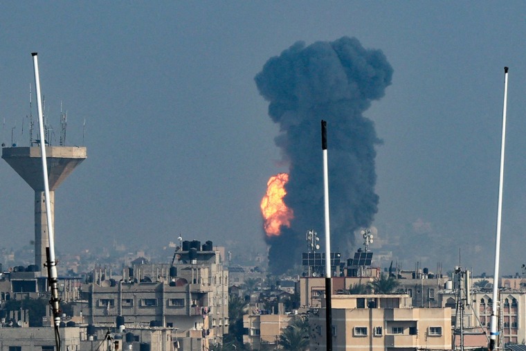  Smoke rises above buildings during an Israeli strike on Rafah in the southern Gaza Strip on Dec. 1, 2023.