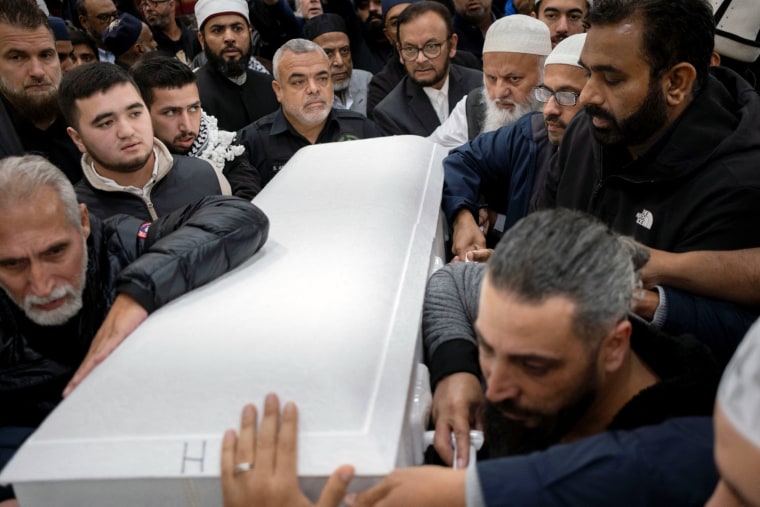 Image: Mourners surround the casket of Wadea Al-Fayoume being carried by his family