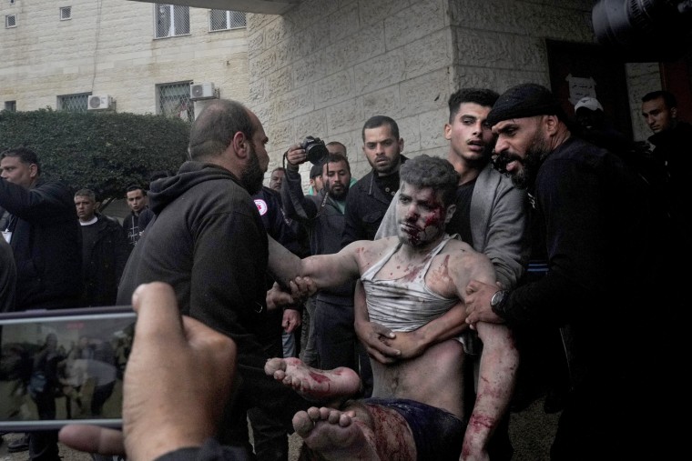 Wounded Palestinians are brought to the hospital in Deir al Balah on Tuesday, Dec. 5, 2023.