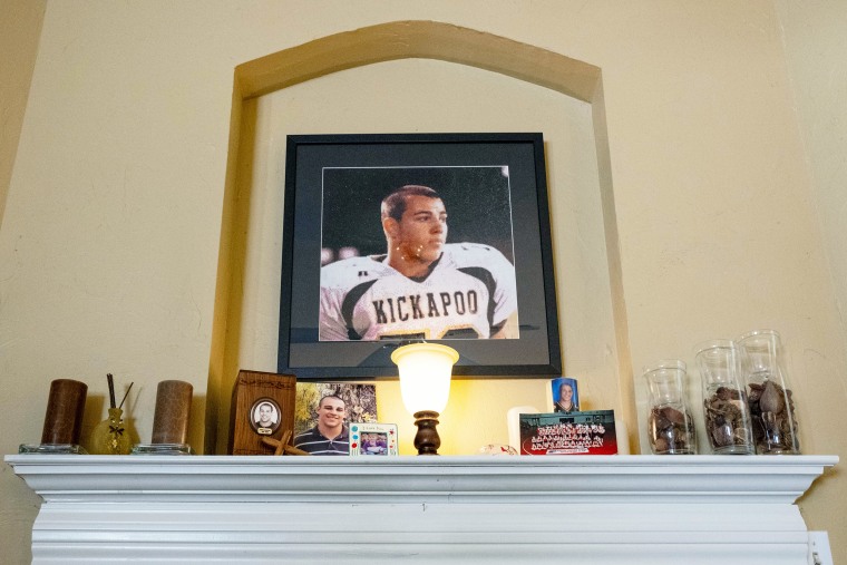 A portrait of Caleb Slay in his high-school football jersey hangs above the mantle in his grandparents' home.