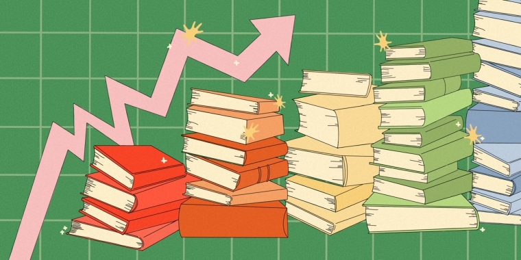 Stacks of books in red, orange, yellow, green and blue sit in front of a graph with an upwards pointing arrow 
