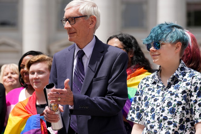 Evers with Aspen Morris at the raising of an LGBTQ flag  at the Capitol in Madison