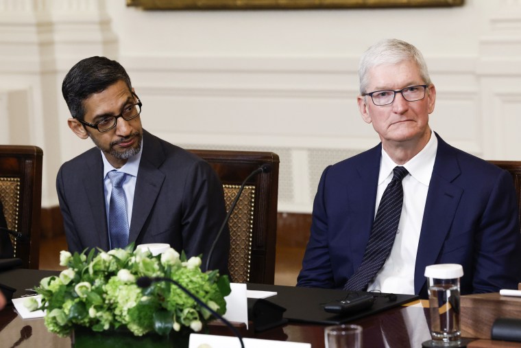 Google CEO Sundar Pichai, left, and Apple CEO Tim Cook  listen as  President Joe Biden speaks during a roundtable with American and Indian business leaders at the White House on June 23, 2023.