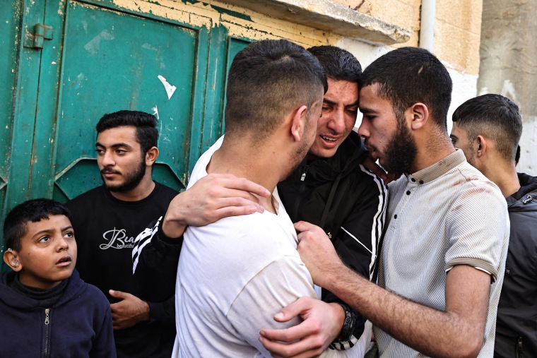 Relatives mourn a man killed during an Israeli raid in the occupied West Bank, on Dec, 8, 2023, during a funeral in the village of al-Fara. 