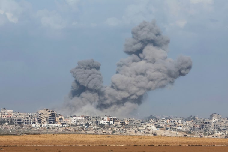 A large plum of smoke rises over the Gaza skyline.