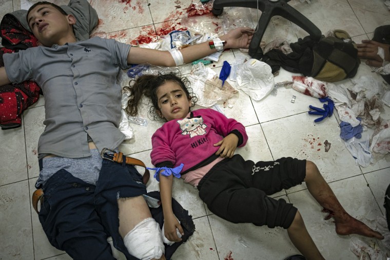 Children wait to be treated at a hospital in Khan Younis, Gaza, on Tuesday Dec. 5, 2023. 
