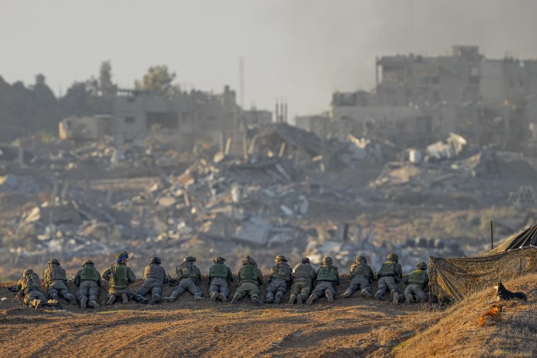 Israeli soldiers take positions near the Gaza Strip border in southern Israel on Dec. 11, 2023.