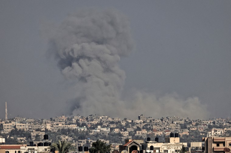 Smoke billows over Khan Younis in the southern Gaza Strip after an Israeli strike on Dec. 11, 2023.