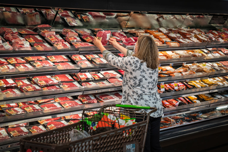 A shopper looks at a meat display  in South Burlington, Vt., in 2022.