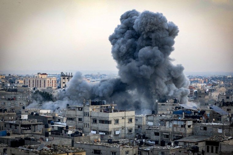 A smoke plume erupts during an Israeli bombardment in Rafah in the southern Gaza Strip on Dec. 12, 2023.