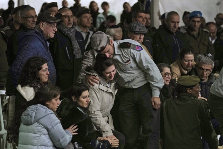Mourners attend the funeral of Lt. Col. Tomer Grinberg at the Mt Herzel military cemetery in Jerusalem on Dec. 13, 2023. 