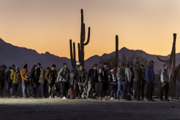 Migrants line up at a Border Patrol processing center.