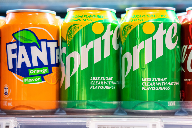 Cans of Sprite and Fanta, both produced by the Coca-Cola Company. 