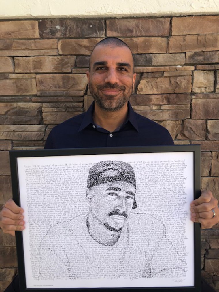 Scholar Barbod Salimi holding artwork of Tupac Shakur by artist Dan Duffy.